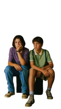 two boys sitting on top of a black box